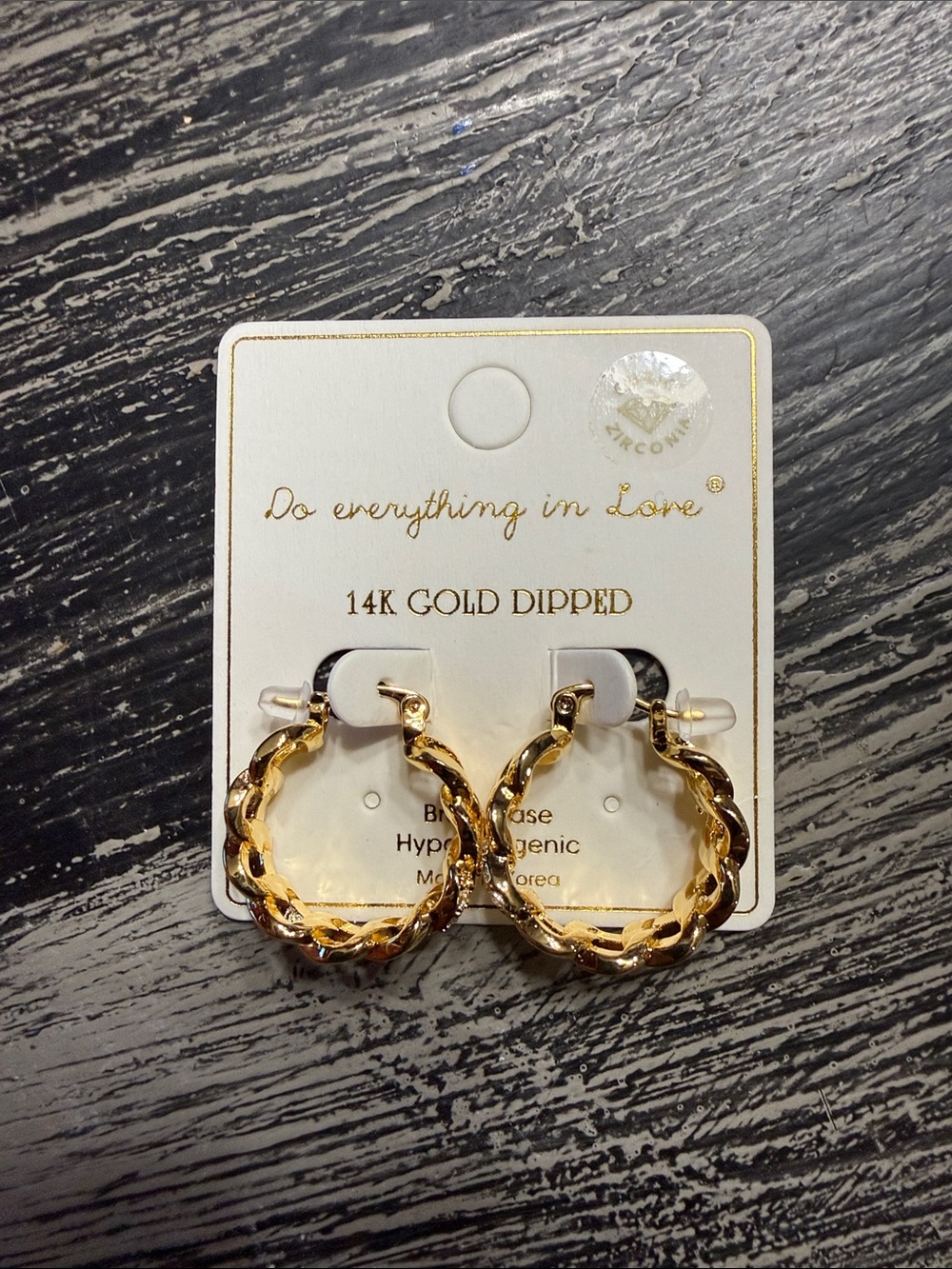 Do everything in Love Gold Twisted Hoop Earrings